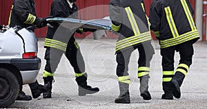 after road accident the firefighters remove the hood of the acci photo