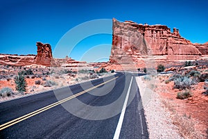 Road across Arches National Park at sunset, Utah