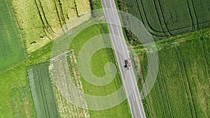 Road through agricultural fields - tracking shot, high angle view