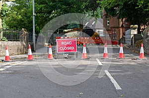 Road ahead closed sign and traffic cones