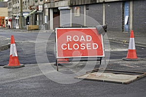 Road ahead closed sign and traffic cones