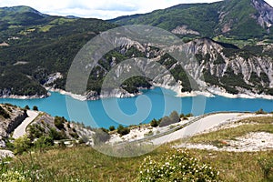 Road along Lake Serre-Poncon in the Hautes-Alpes, France