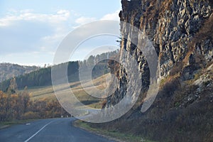 The road is along a steep cliff. Mountain Altai. Russia.