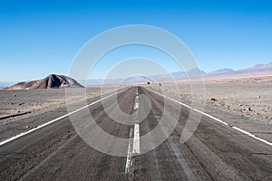 Road into the Atacama Desert. Barren rocky landscape, arid mountains and hills in the San Pedro de Atacama area.