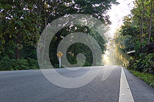 Road background image free space road in a tropical forest in Thailand, curvy path, rural road, selectable focus.