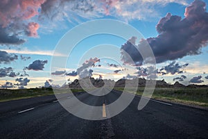 Road through Bad Lands in South Dakota at sunset