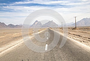 Road through the Bafgh desert near Yazd photo
