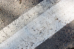 The road with the barbell string. Asphalted stone without lysing details. Last summer