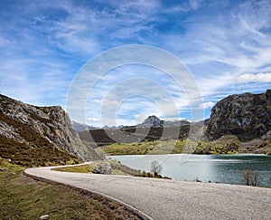 A road with a beautiful view near Lake Enol at sunny day , Picos de Europa Western Massif, Cantabrian Mountains, Asturias, Spain photo