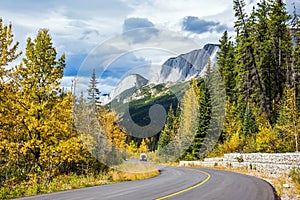 The road bends in the woods and mountains