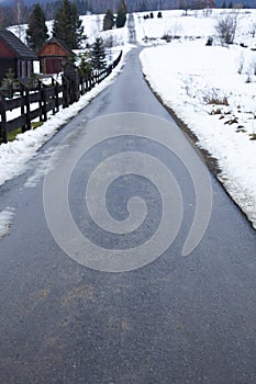 Road in Bieszczady to Wetlina and Solina, Winter day with lot of snow. Buildings in the background