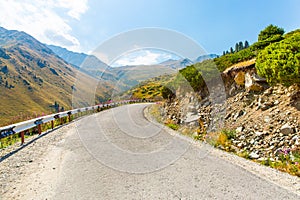 Road on Big Almaty Lake, nature green mountains and blue sky in Almaty, Kazakhstan