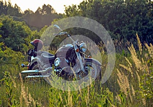 Road bike in a glade in the rays of the setting sun