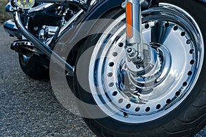 Road bike. view of the front chrome wheel of a motorcycle. cruiser
