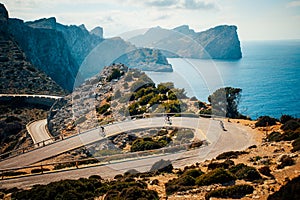Road bikers on the road on Balearic Islands. Sea in Background. Cap de Formentor. Mallorca, Majorca, Spain