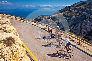 Road bikers on the road on Balearic Islands. Sea in Background. Cap de Formentor. Mallorca, Majorca, Spain