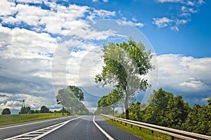 Road and blue sky with clouds in a sunny day