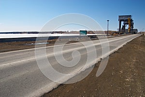 Road, blue sky and powerstation