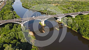 Road bridge with cars in sunlight, aerial view.