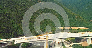 Road bridge construction. Aerial top view of bridge construction over the highway. View from above highway road repair