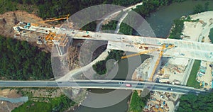 Road bridge construction. Aerial top view of bridge construction over the highway. View from above highway road repair