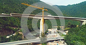 Road bridge construction. Aerial top view of bridge construction over the highway. View from above highway road repair