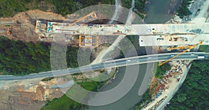 Road bridge construction. Aerial view of bridge construction over highway. View from above highway road repair. Building