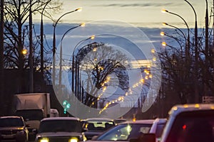 Road bridge with the lights and moving car in the fog after rain.