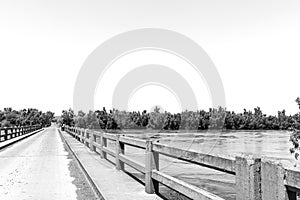 Road bridge over flooded Orange River at Grootdrink. Monochrome