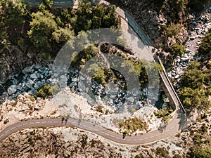 Road and bridge over mountain stream in Corsica