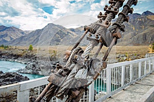 Road bridge over the river in the mountains, metal structure close-up. Location Gorny Altai, Siberia, Russia