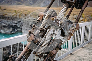 Road bridge over the river in the mountains, metal structure close-up. Location Gorny Altai, Siberia, Russia