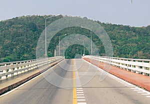 Road bridge over the sea mountainous background