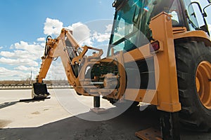 Road-building machinery, tractors yellow excavators in open air in working position