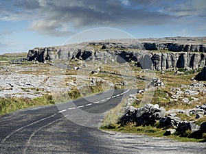 Road in Burren National park, county Clare, Ireland, Sunny warm day, Cloudy sky