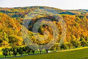 Road with car in czech countryside in autumn