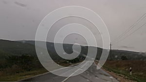 Road car rain. Close-up of windshield wipers sliding on the windshield of a car