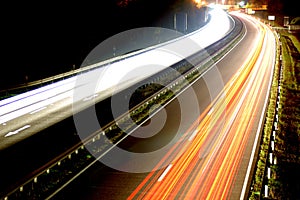 Road with car traffic at night with blurry lights