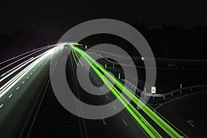 Road with car traffic at night with blurry lights