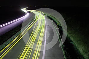 Road with car traffic at night with blurry lights