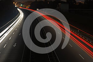 Road with car traffic at night with blurry lights