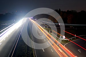 Road with car traffic at night with blurry lights