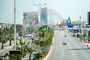 Road with cars and city downtown in background, Dammam, Saudi Arabia photo