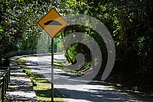 Road cautionary sign indicating speed breaker ahead. Sign indicating to slowdown as speed bump in road