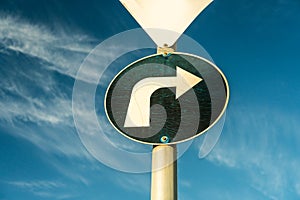 Road circle sign with arrow to the right and blue sky on background. Street object for transport and traffic safety drive