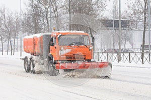 Road cleaning snow-removing machine in the city after huge snowfall. photo