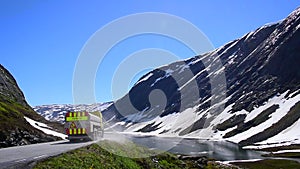 Road cleaning truck sweeping streets in beautiful mountain landscape