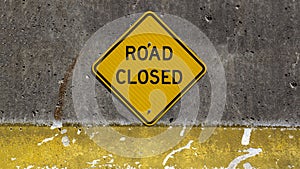 Road Closed sign on concrete barrier