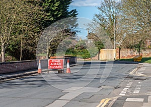 Road closed sign with cones