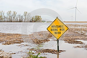 Road closed sign and high water flooding roadway